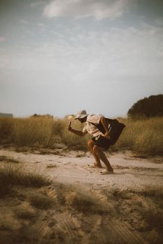 A person enjoying a dynamic pose in the sandy Dubai desert under a clear sky.