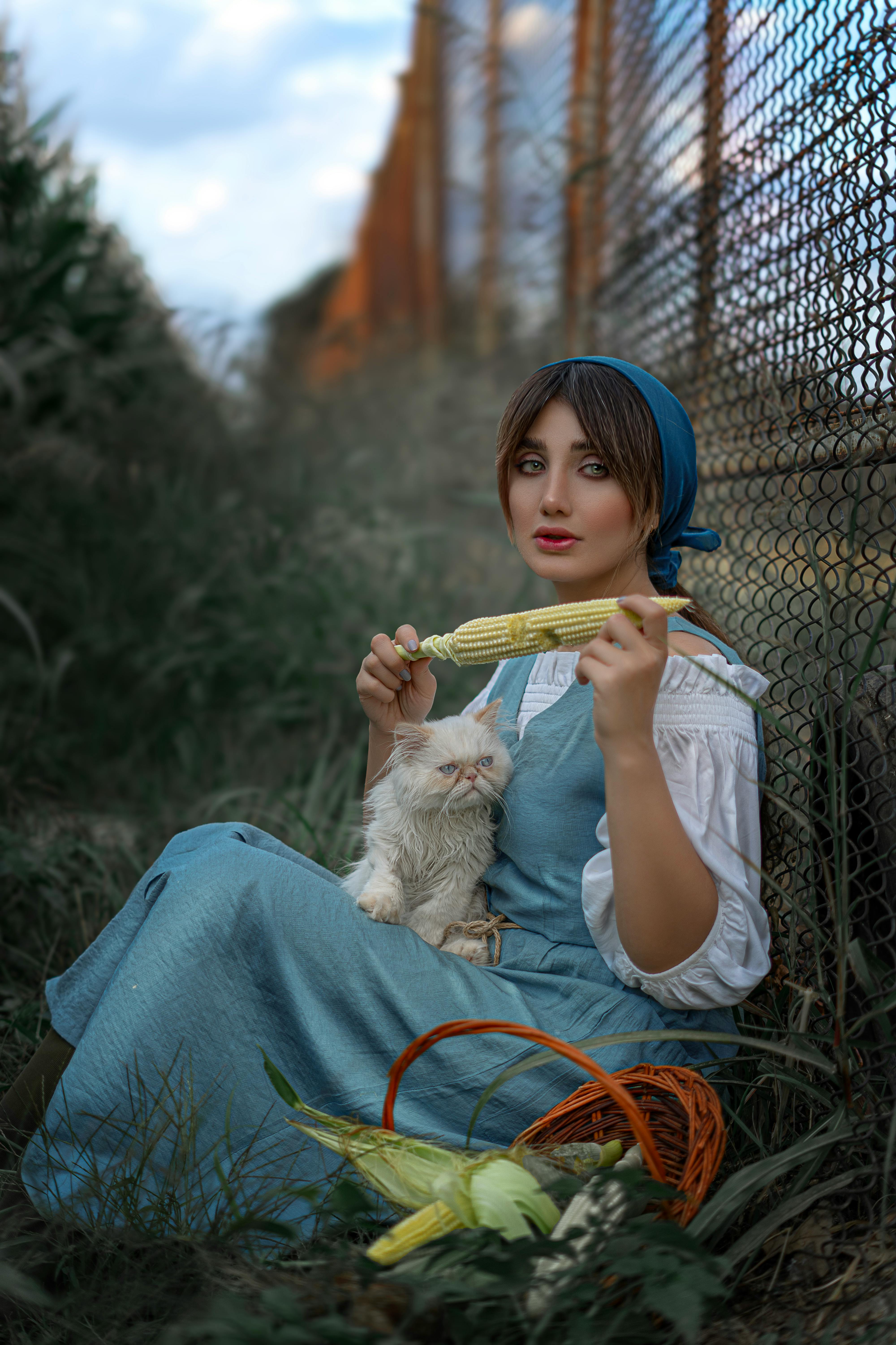 young woman with cat and corn in qazvin outdoors