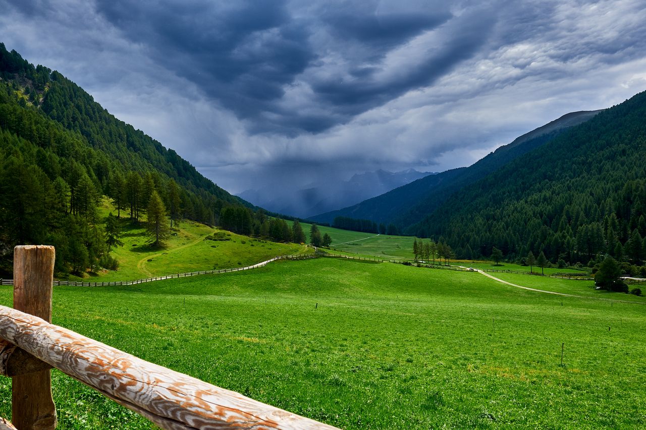 beautiful green valley under cloudy skies in schlinig trentino s dtiro