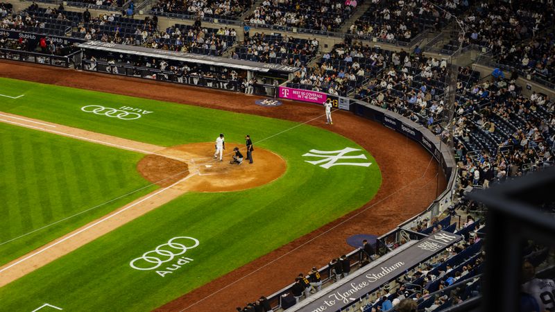 Aerial view of a baseball game at Yankee Stadium with a packed crowd.