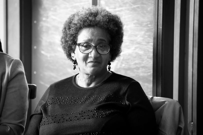 Portrait of an older Black woman wearing glasses, the demographic most affected by Alzheimer's disease and most often diagnosed late.