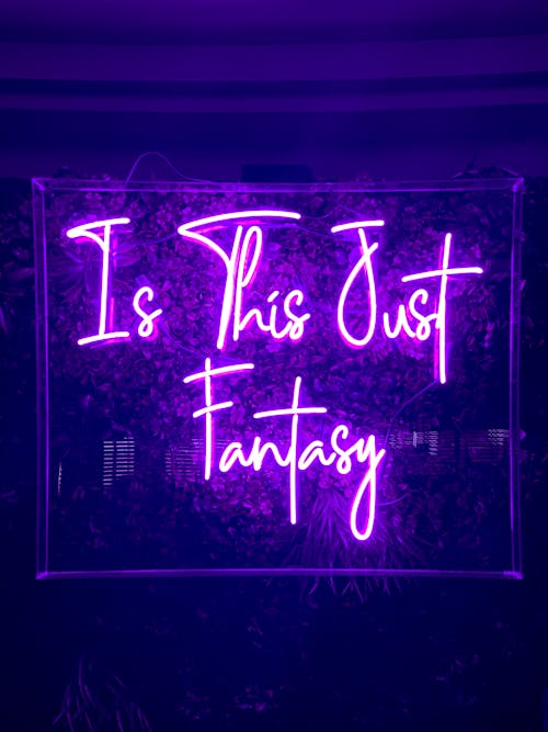 A neon sign that reads "Is This Just Fantasy."