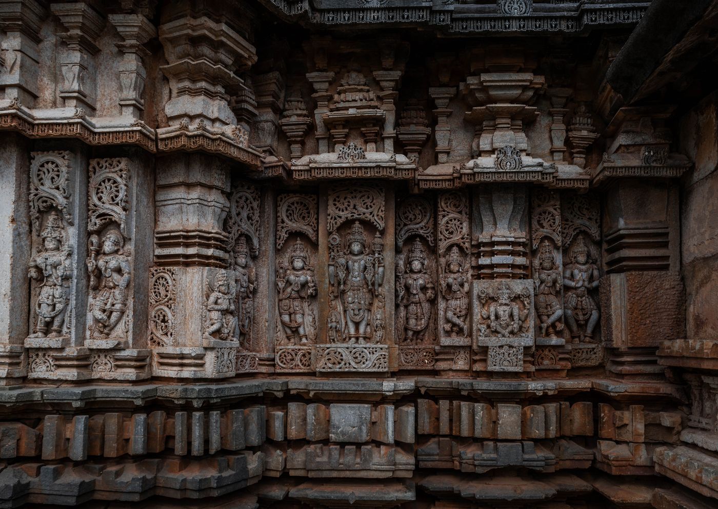 Carved Hoysala stone wall in soft light — representative image