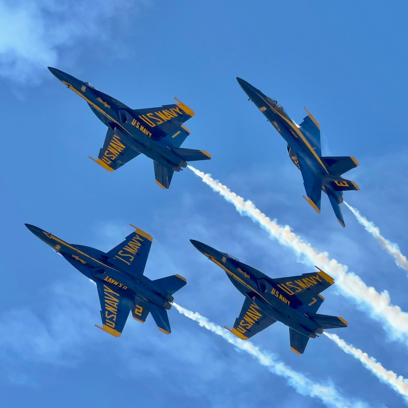 Blue Angels flying in diamond formation during an airshow in San Diego.
