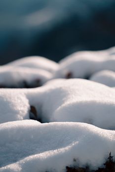 Close-up of snow-covered rocks capturing the winter season's serene beauty.