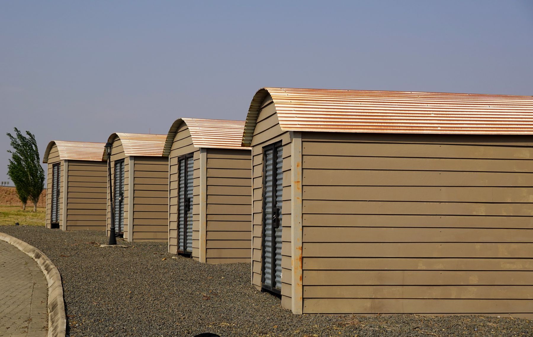 Identical modern modular units aligned on a gravel surface