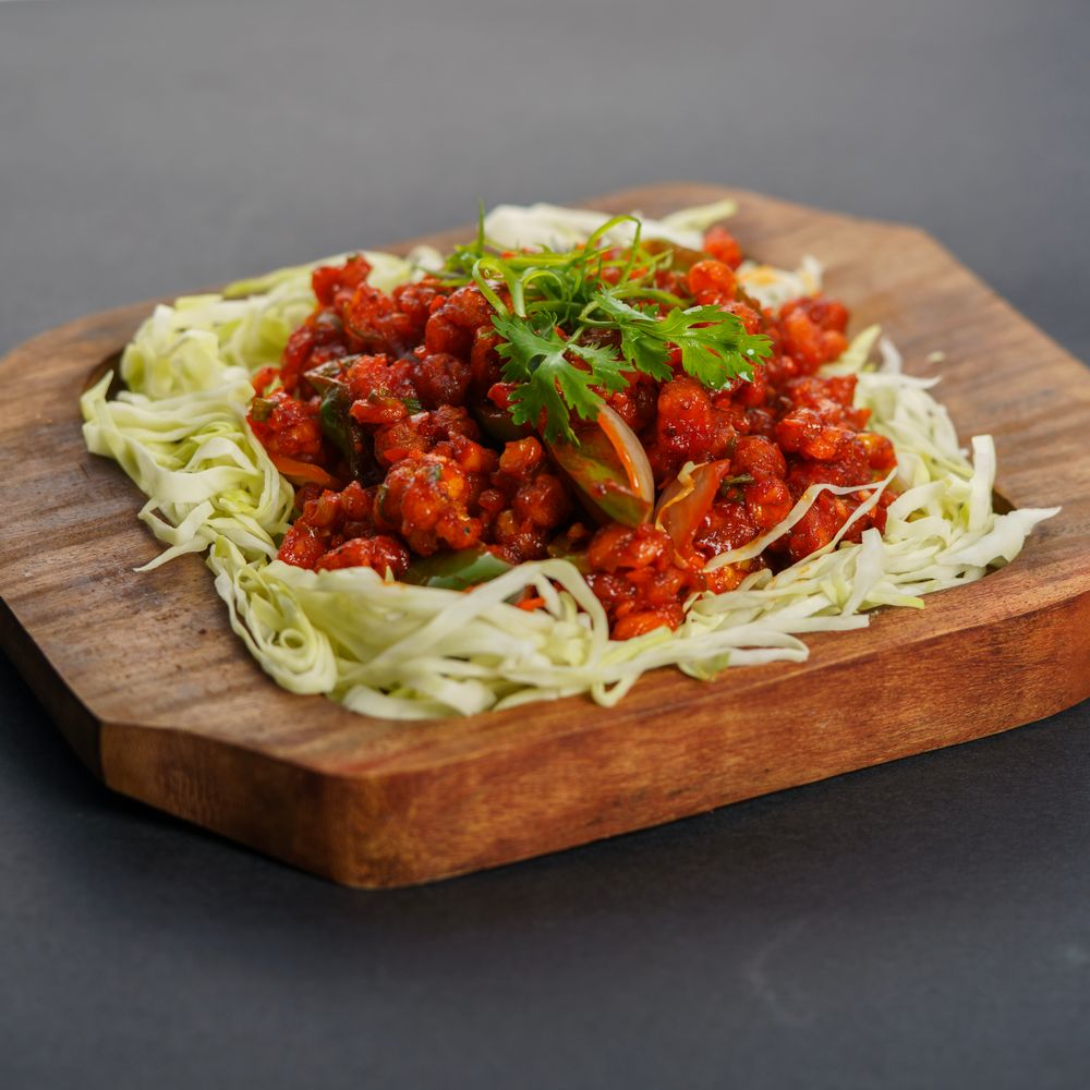Gobi Manchurian garnished with spring onion and cilantro