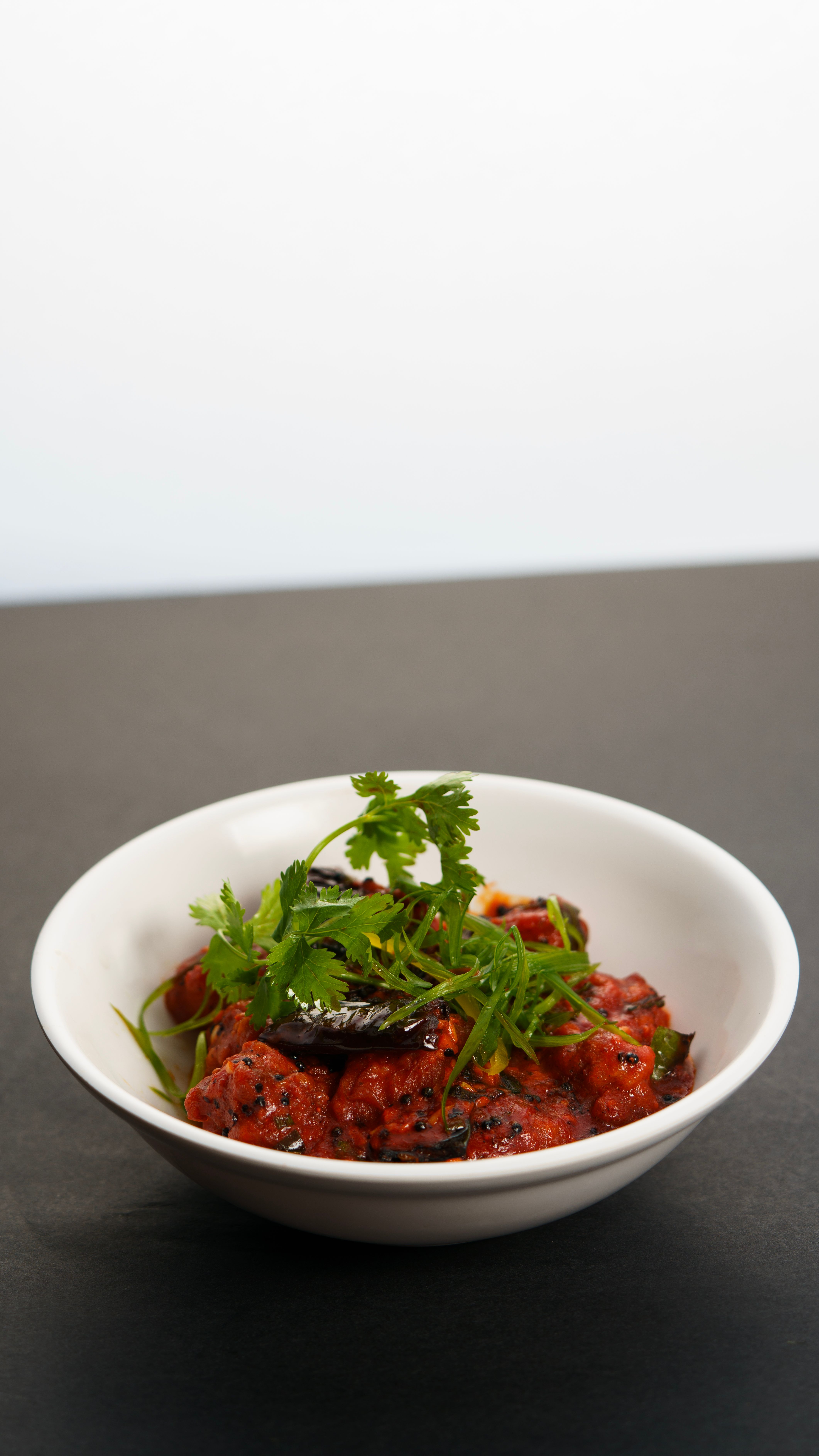 Delicious Indian Manchurian dish garnished with fresh cilantro, perfect for food enthusiasts.