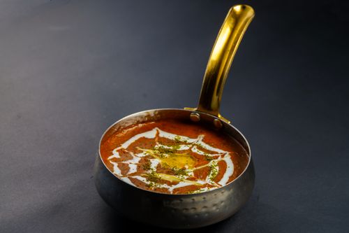 Free Rich and creamy dal makhani served hot in a traditional Indian pan. Perfect for food lovers. Stock Photo
