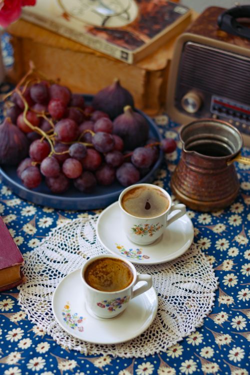 Free Charming vintage coffee scene with grapes, a retro radio, and decorative cups. Stock Photo