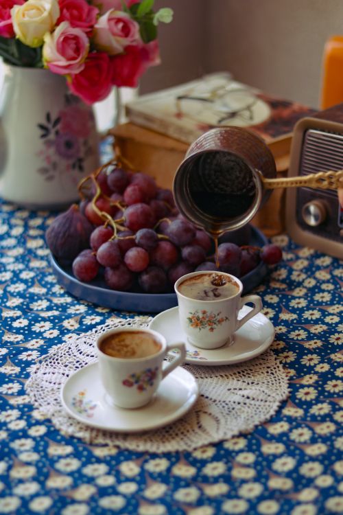 Free Authentic Turkish coffee served with ripe grapes and roses, creating a cozy and vintage ambiance. Stock Photo