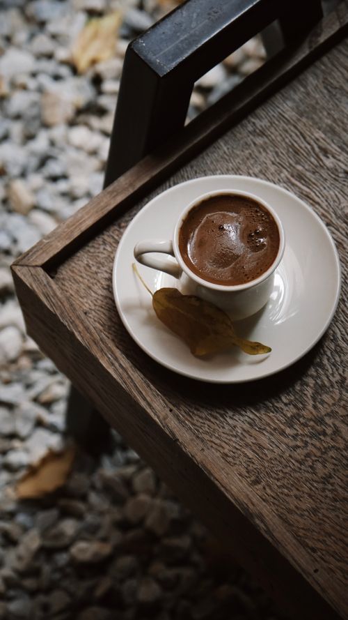 Free A cup of traditional Turkish coffee with a leaf on a rustic table in Bursa, Türkiye. Stock Photo