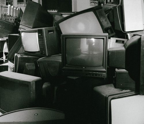 Free A stack of retro televisions evokes nostalgia and past technology in black and white. Stock Photo