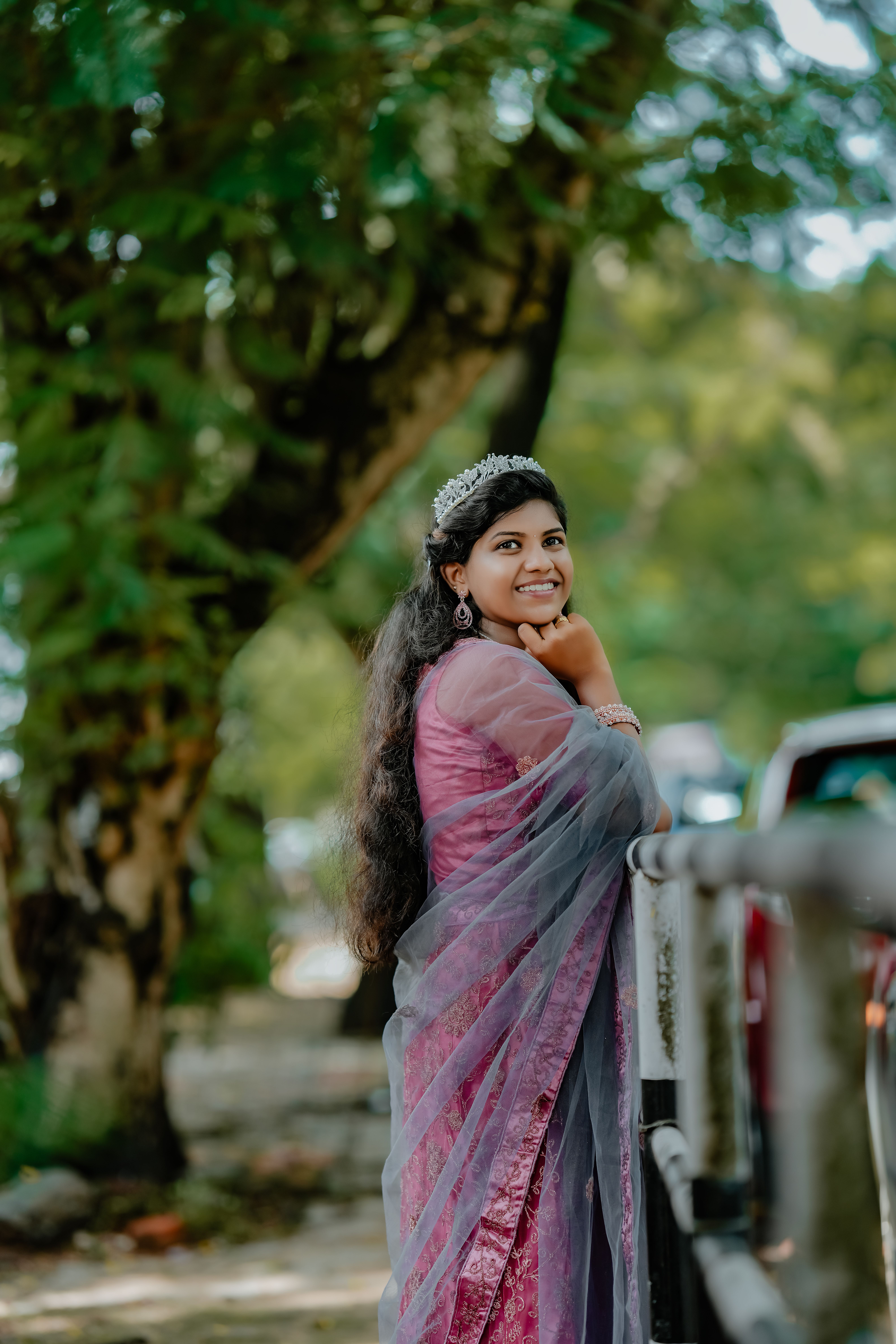 Elegant Woman Smiling Outdoors in Traditional Attire · Free Stock Photo