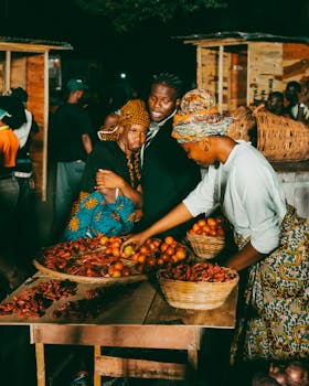 Lively scene at a night market with vendors selling fresh produce