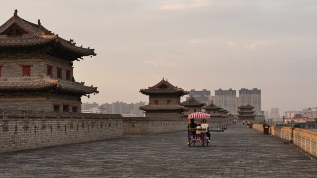 Cyclists enjoy a ride along the historic Xi'an City Wall at sunset. — lounges at Xian Airport