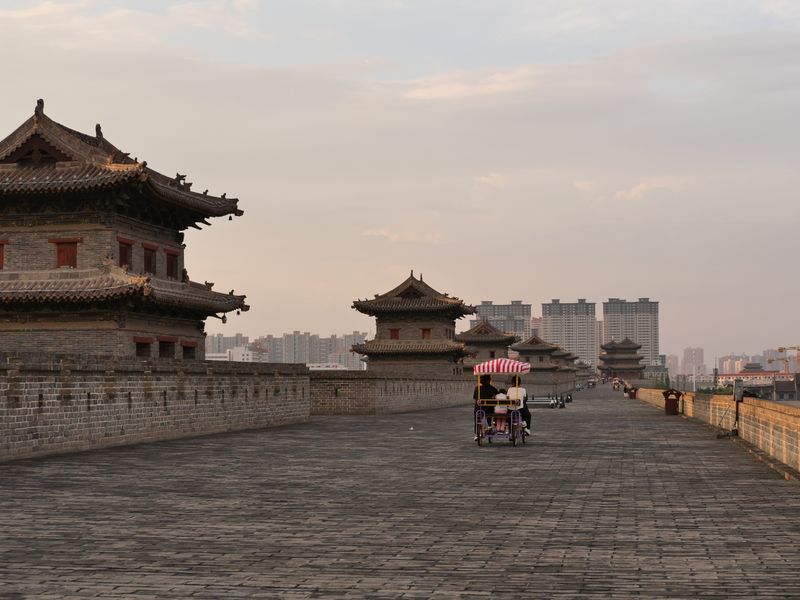 Cyclists and lanterns on the Xi'an city wall at sunset