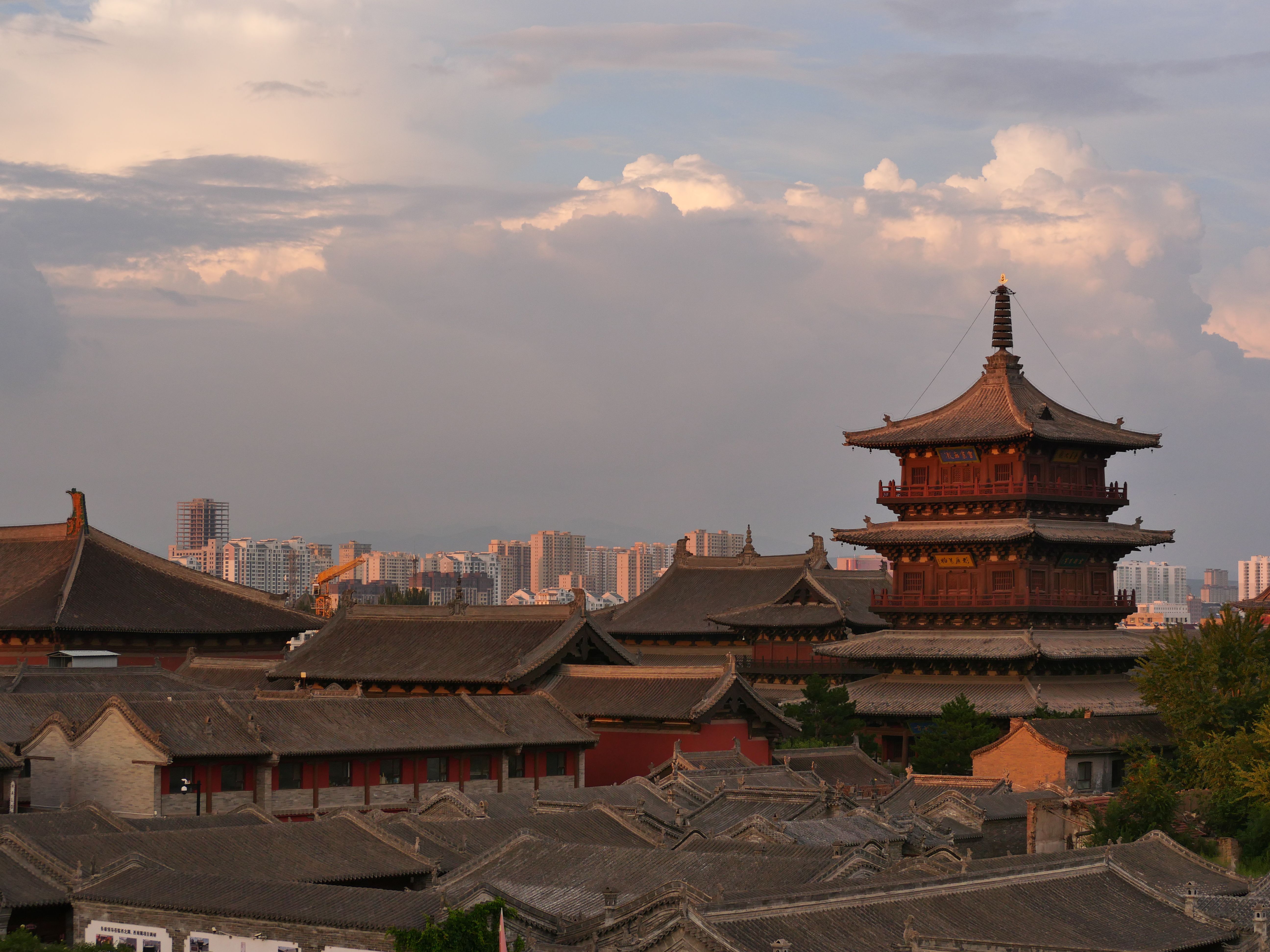 Ancient Chinese Temple and Modern Cityscape at Sunset · Free Stock Photo