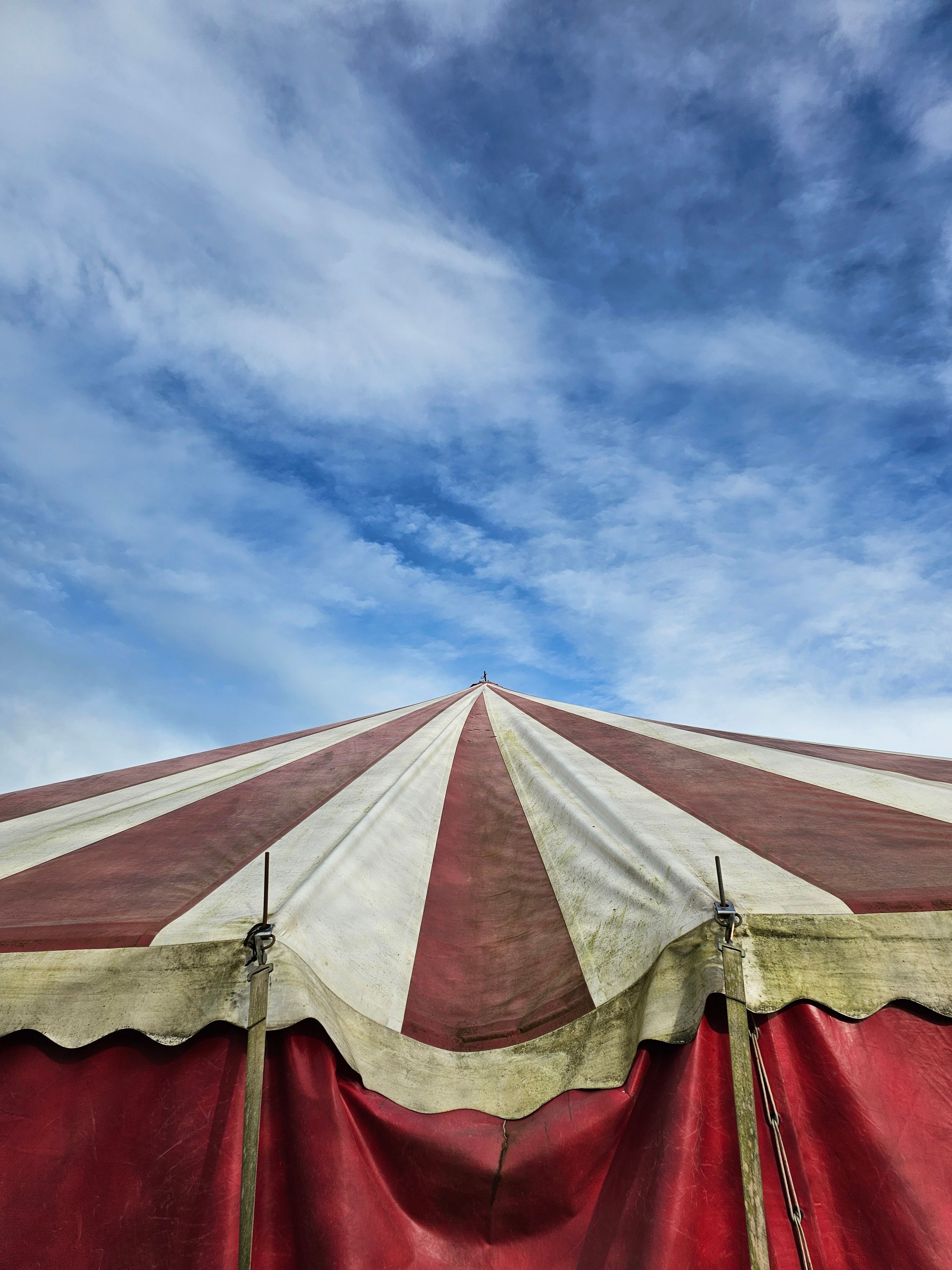 Red and White Striped Circus Tent Under Cloudy Sky · Free Stock Photo