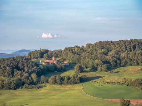 Free Aerial view of a peaceful countryside landscape with lush green fields and a distant horizon. Stock Photo