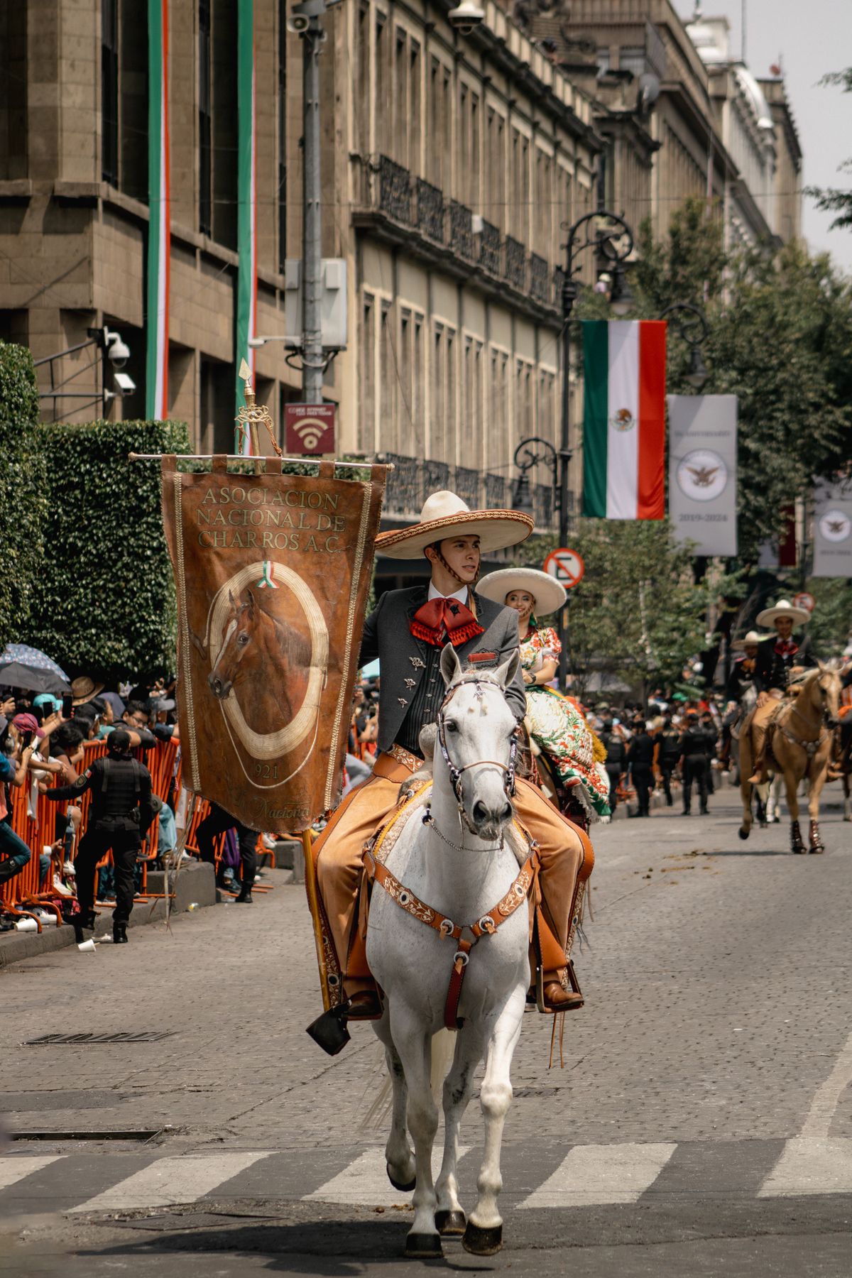 Charros on horseback during the Mexican Independence Day parade in Mexico City's historic center.