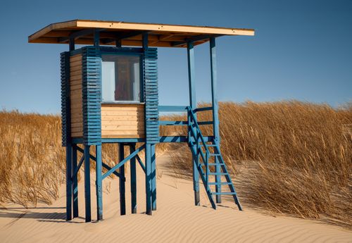Free A solitary lifeguard hut on a quiet, sandy beach in Ventspils, Latvia, during autumn. Stock Photo