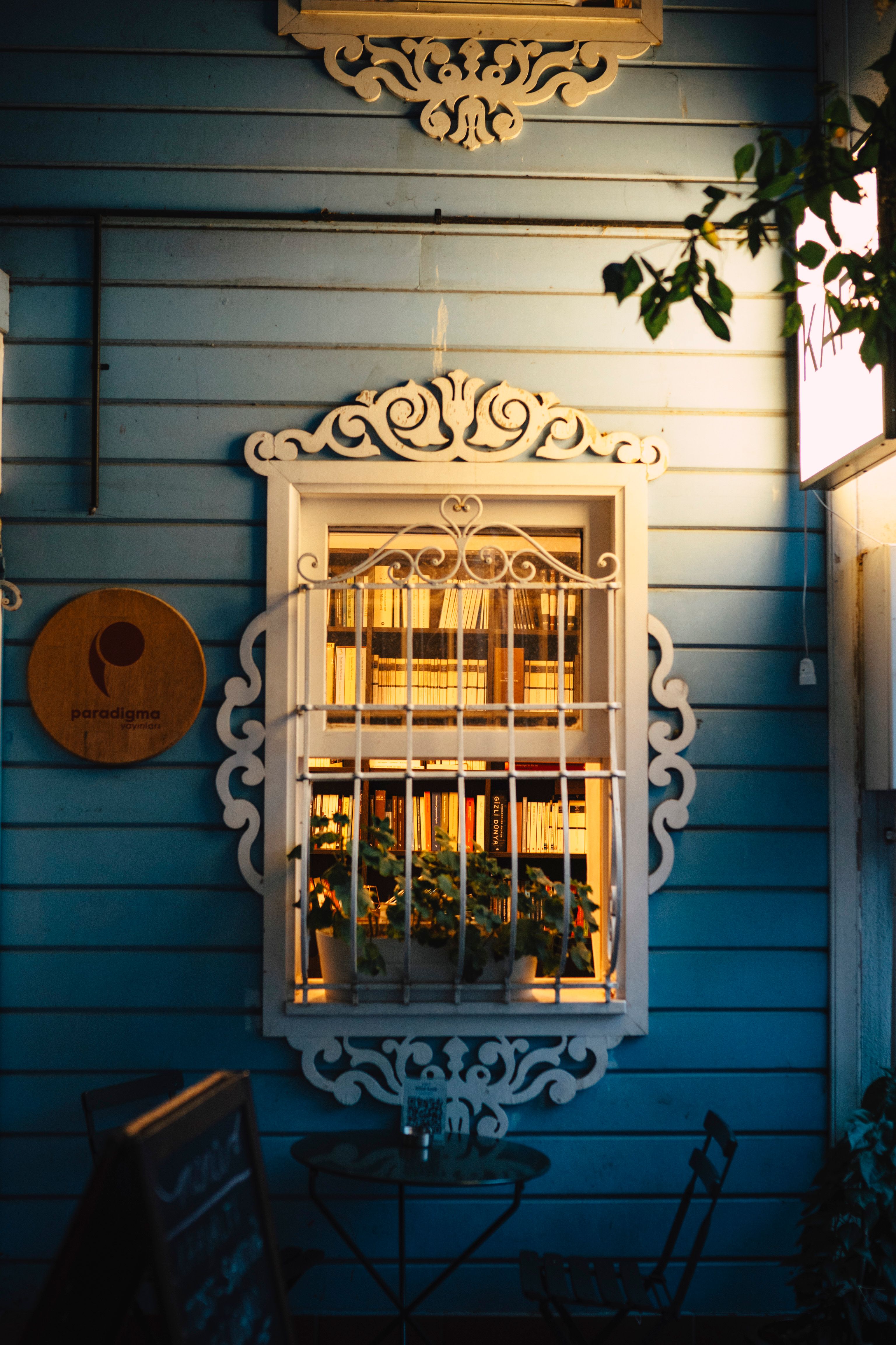 Cozy Evening Cafe Window with Ornate Details · Free Stock Photo