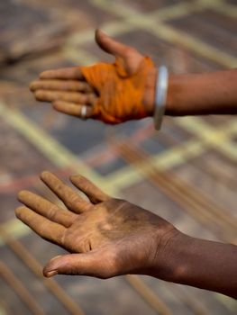 Detailed view of dirty and gloved hands of a worker, illustrating manual labor.