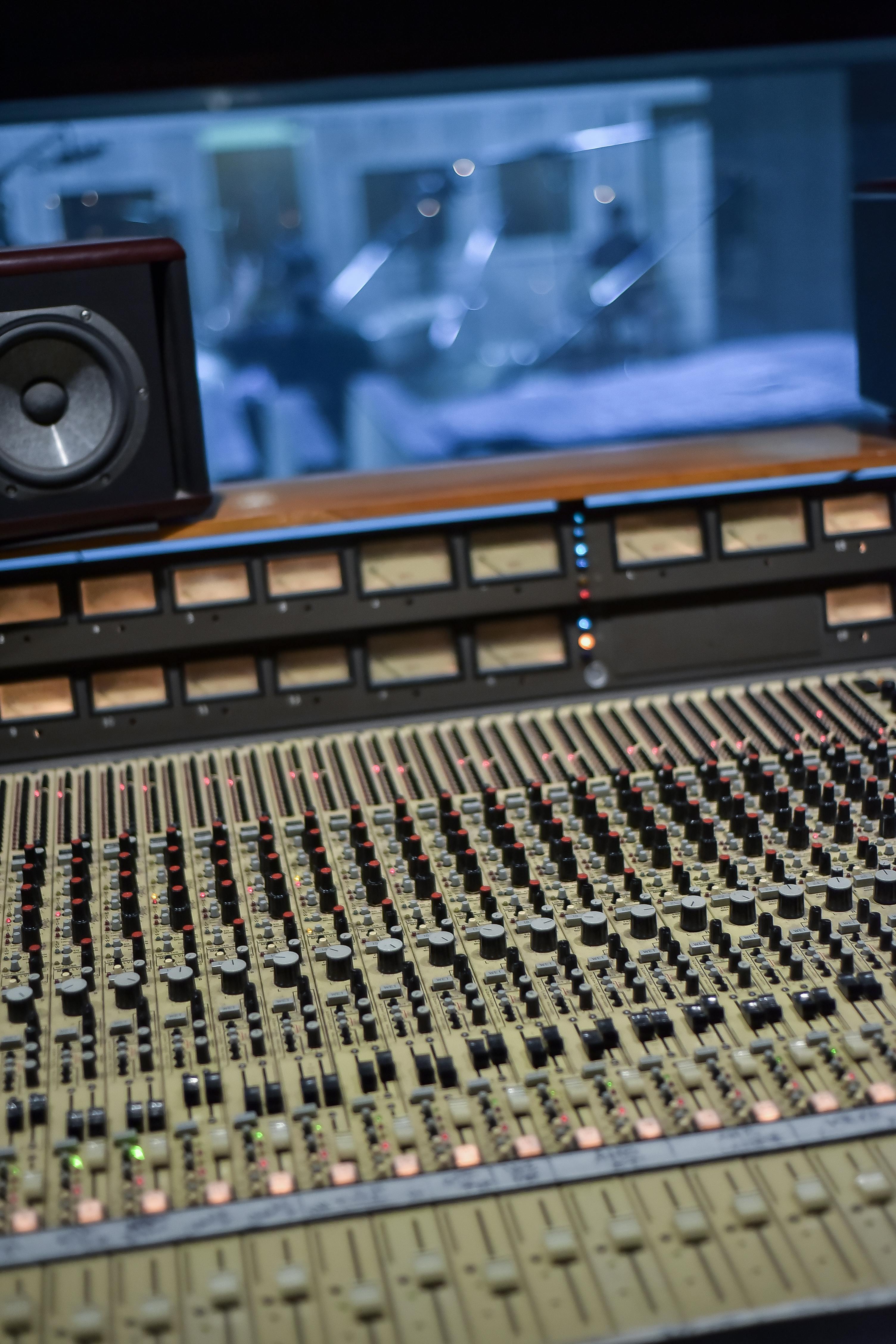 Luxury studio space with custom wooden acoustic panels and sophisticated lighting