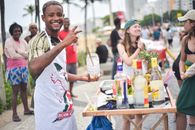 A joyful street scene in Rio de Janeiro, Brazil, with people celebrating around a drink stand.