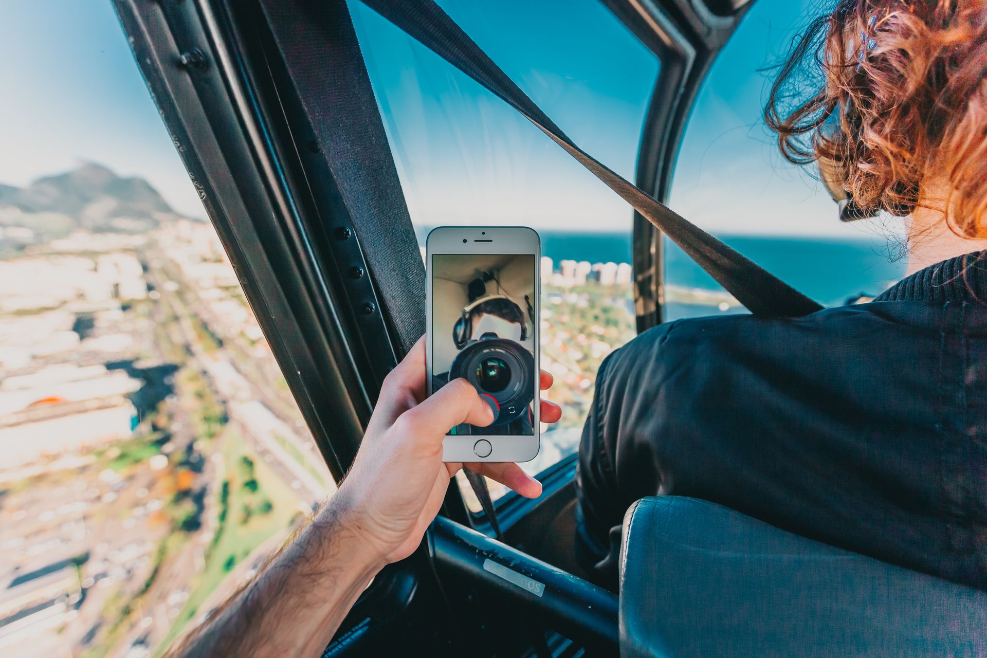 Helicopter ride over Rio de Janeiro captured with smartphone and reflected lens.
