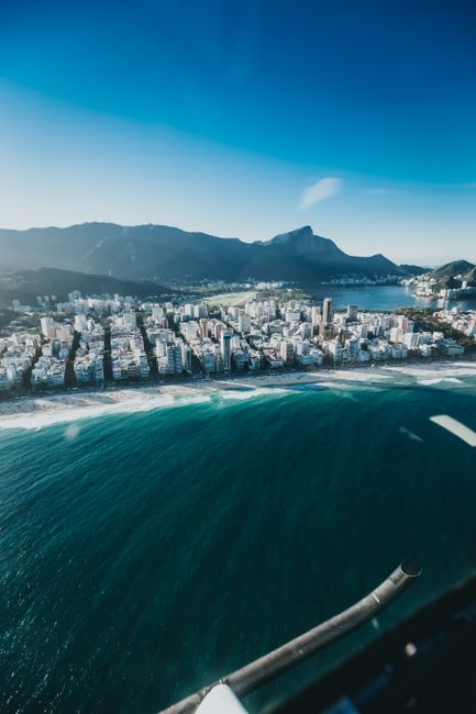 Stunning aerial photograph of Copacabana Beach and urban skyline in Rio de Janeiro, Brazil.