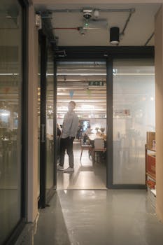 A glimpse into a contemporary office featuring open door and hallway view, London.