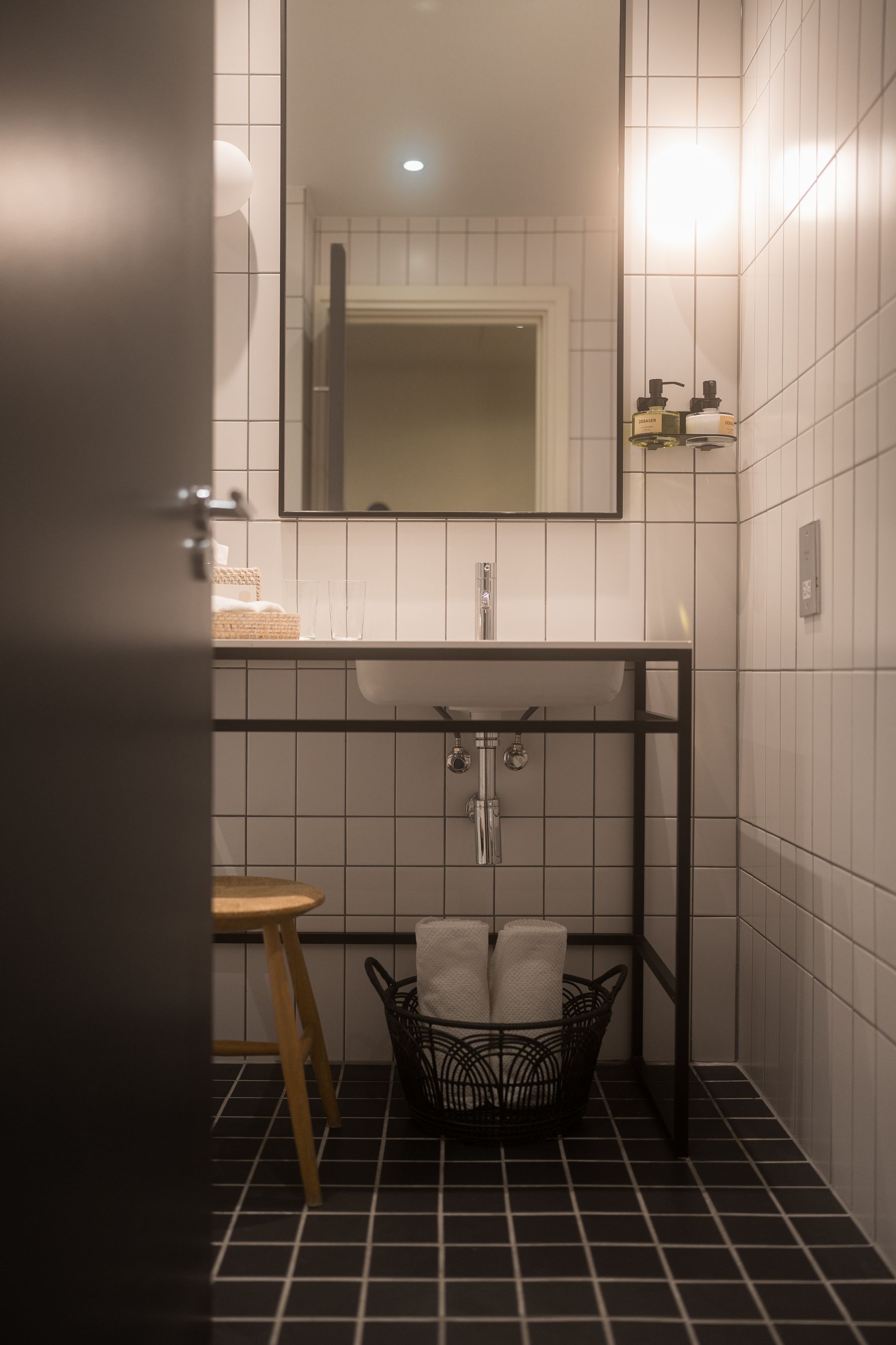Bathroom with geometric black-and-white floor tile and clean modern fixtures