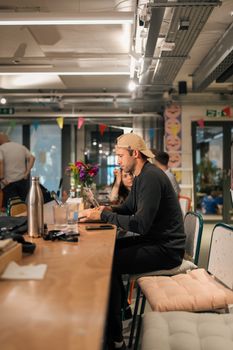 Man working in a modern, casual coworking space in London.