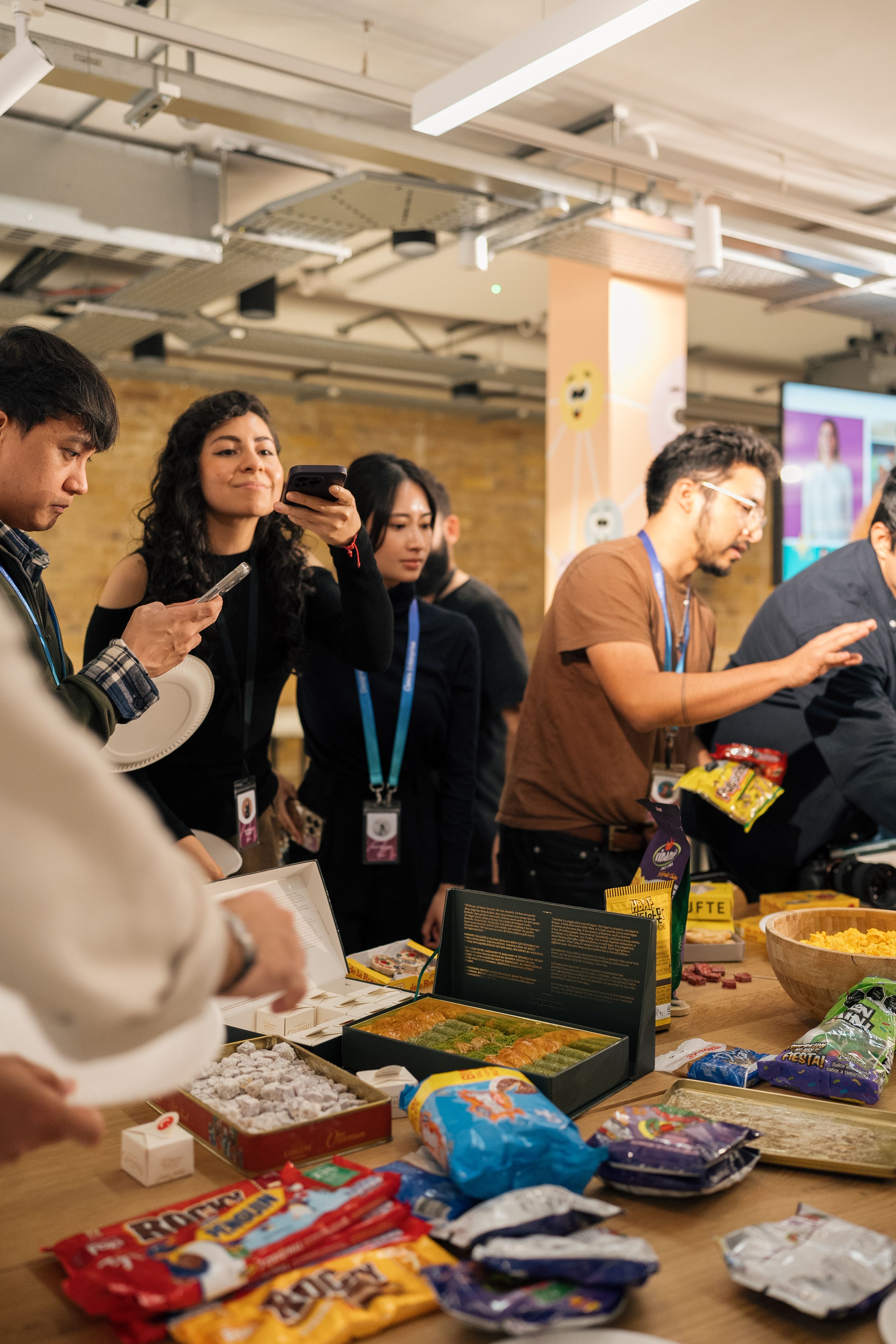 Team gathering in London office with a variety of snacks on display.