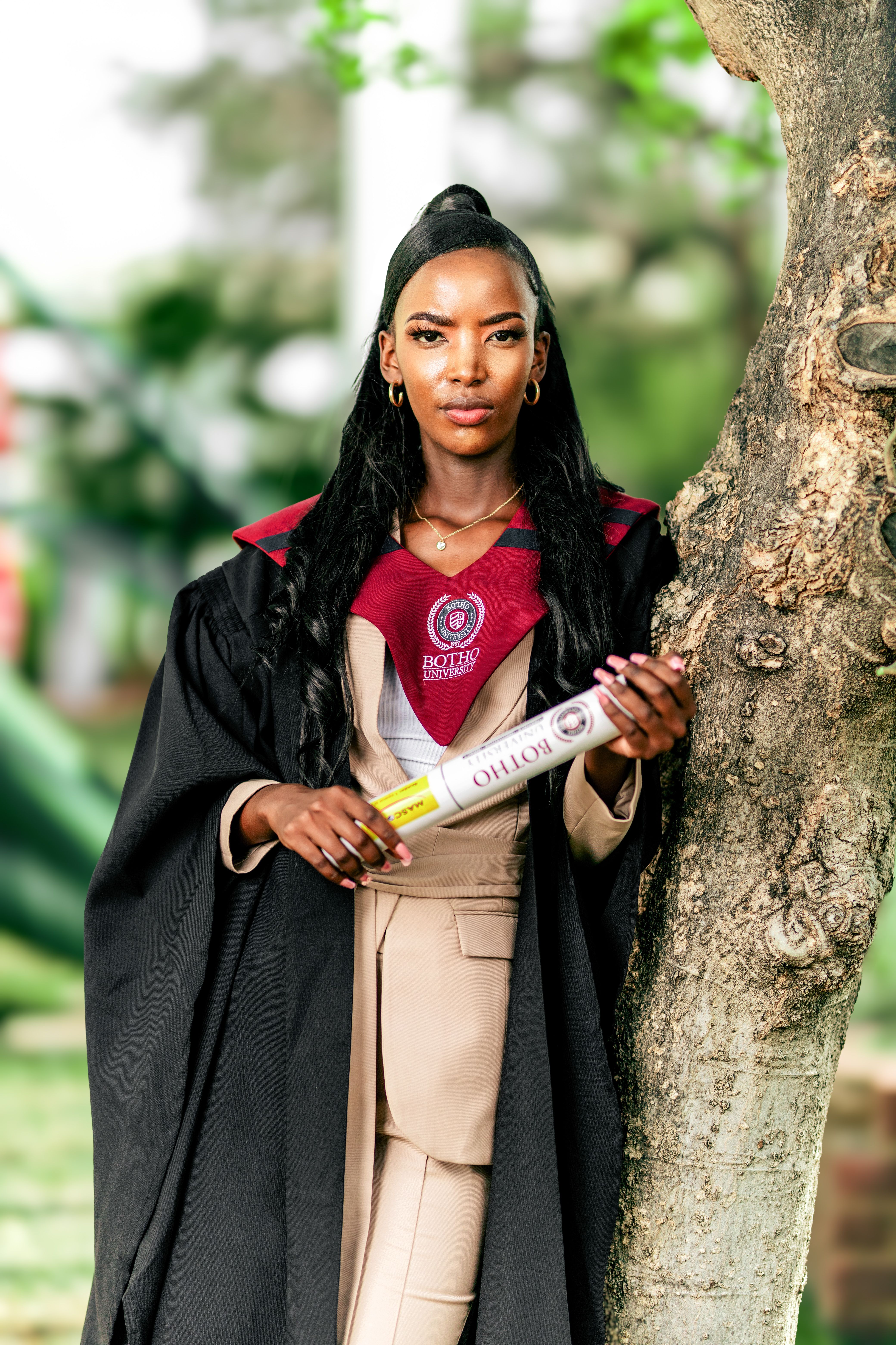 Confident Graduate Holding Diploma Outdoors · Free Stock Photo