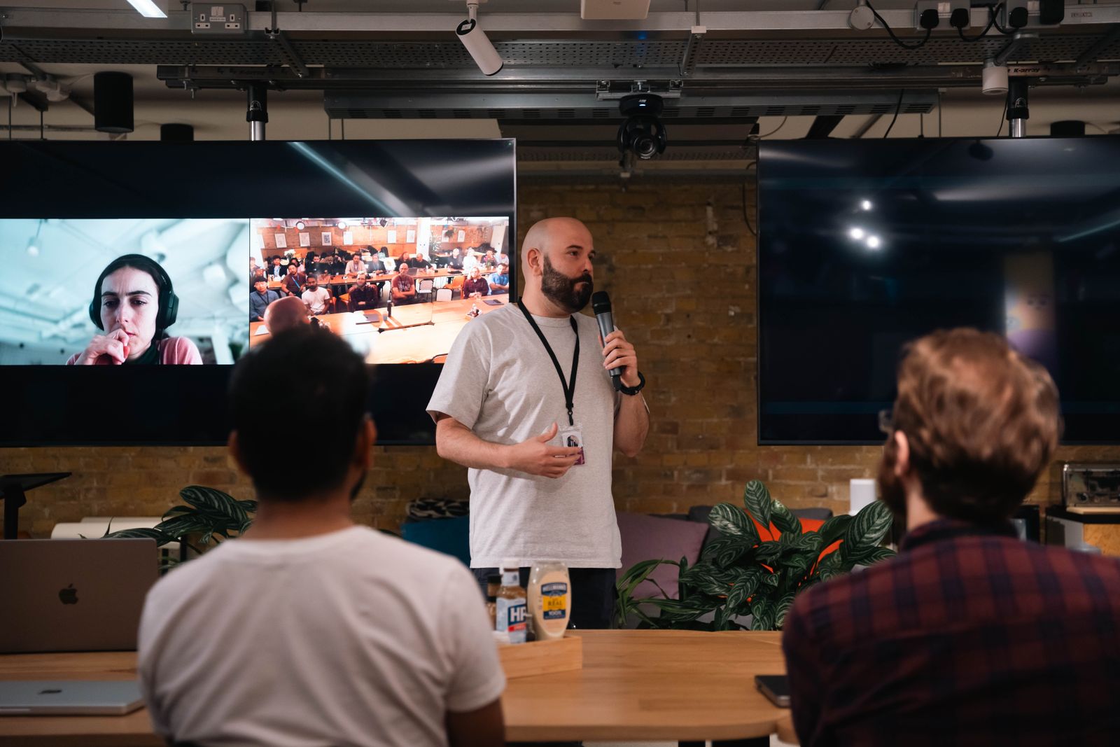 A speaker presenting to a seated audience in a modern office