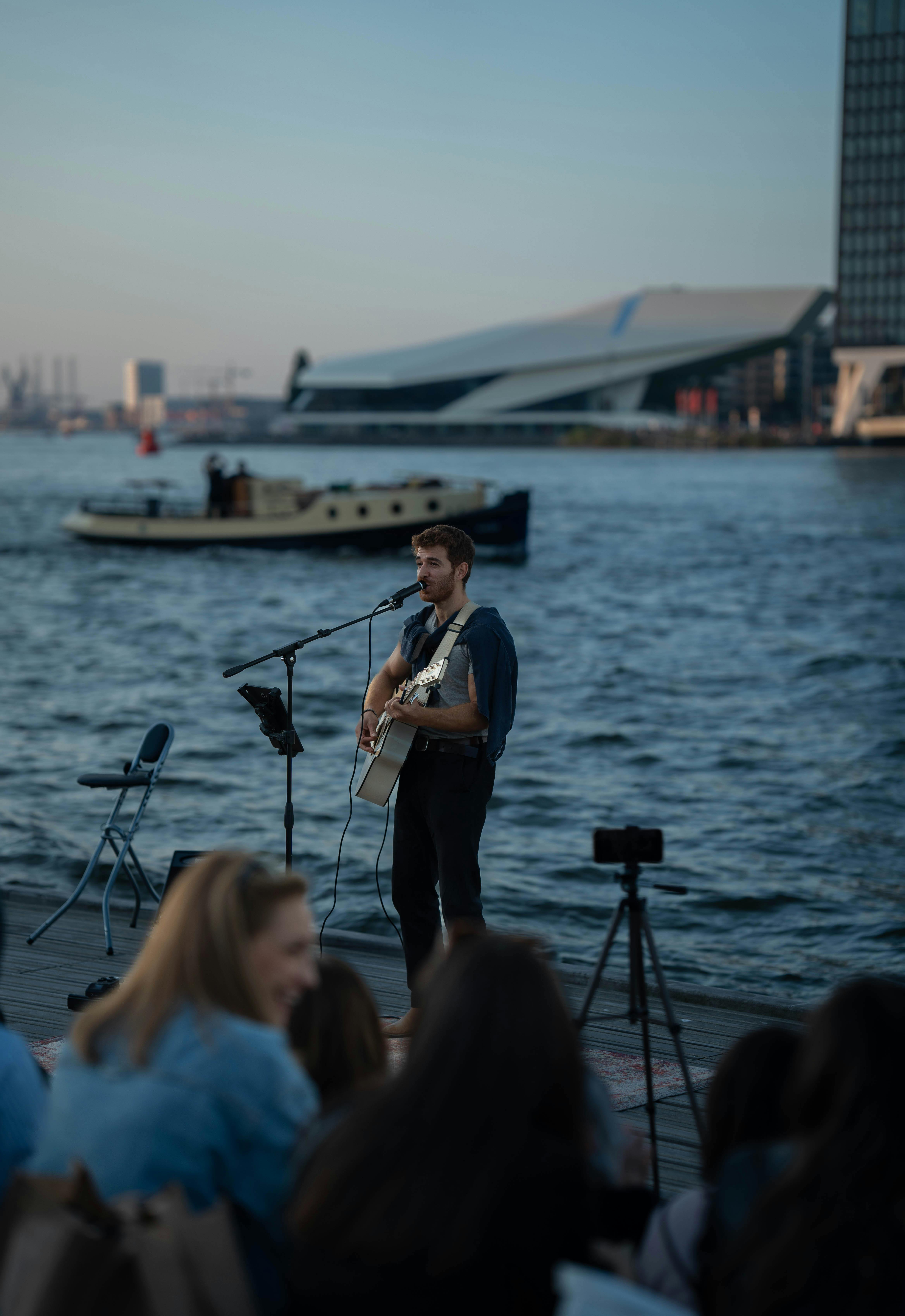 Free outdoor performance at Esplanade Concourse with audience seated on the waterfront promenade in Singapore