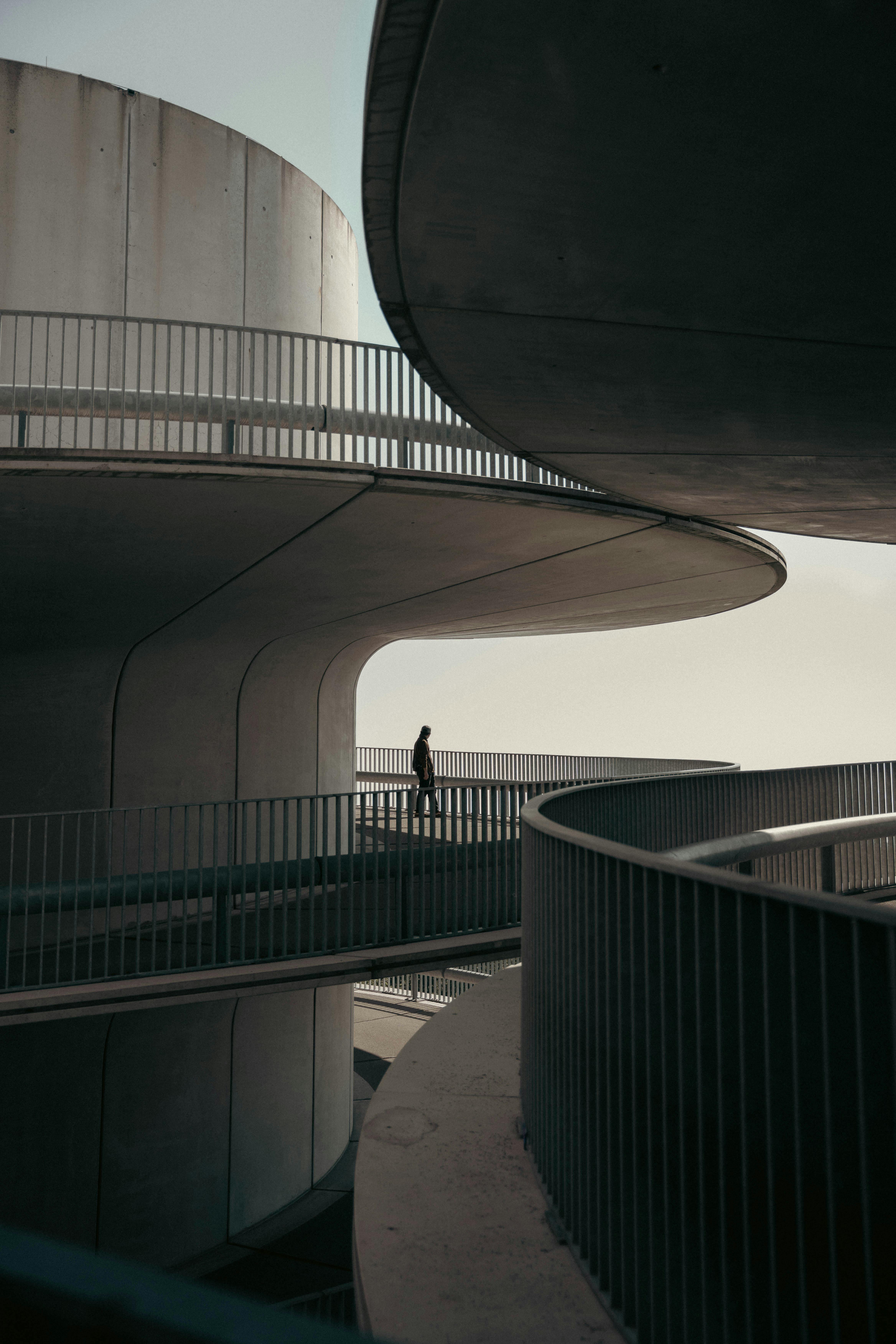 modern architectural walkway with lone figure