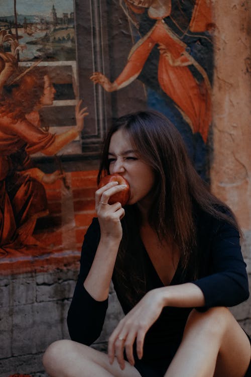 Photo Of Woman Eating Red Apple