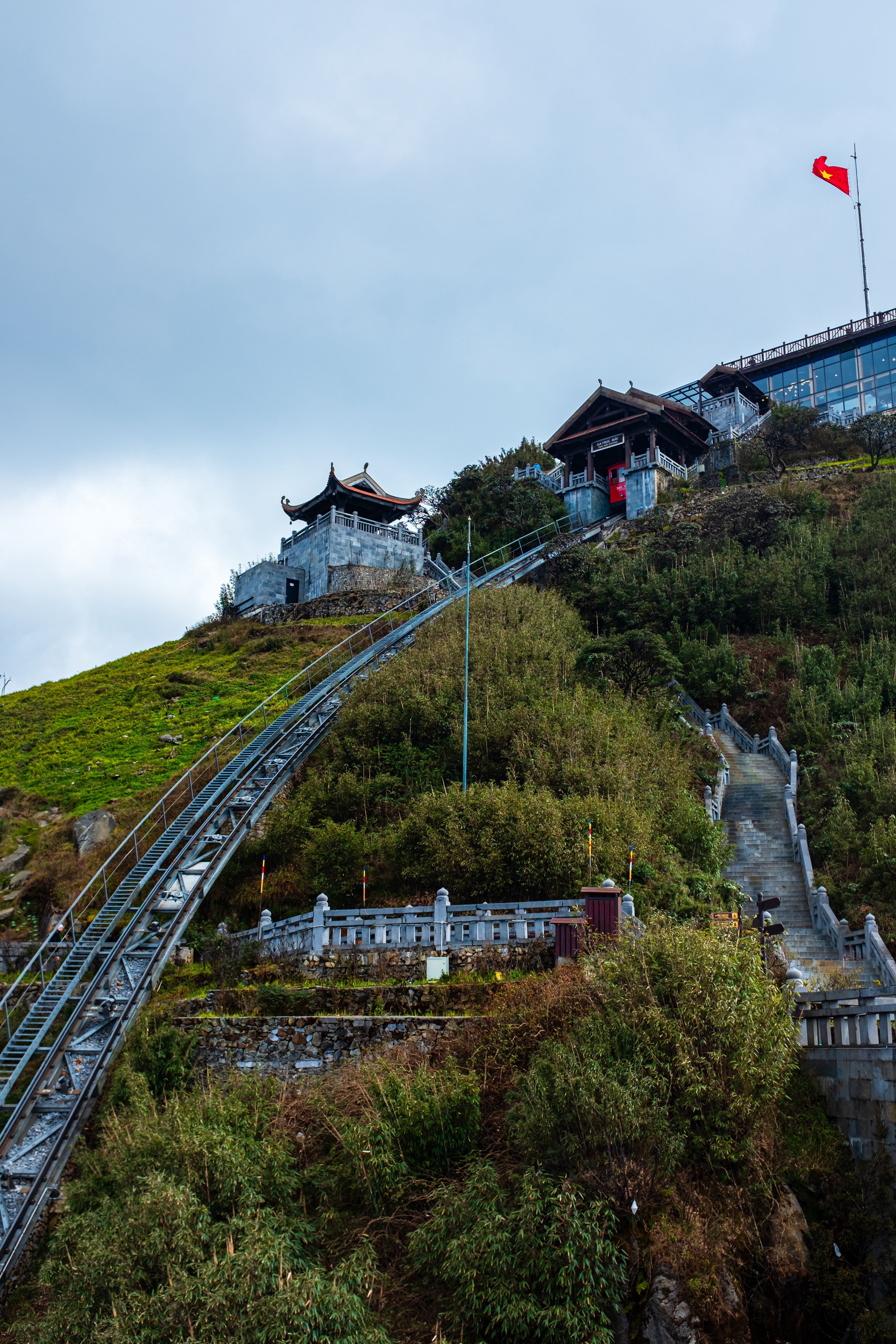 Stunning view of Fansipan Mountain with cable car and temple architecture in Vietnam.