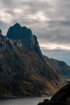 Stunning view of rugged mountain peaks near Tromsø under moody clouds.