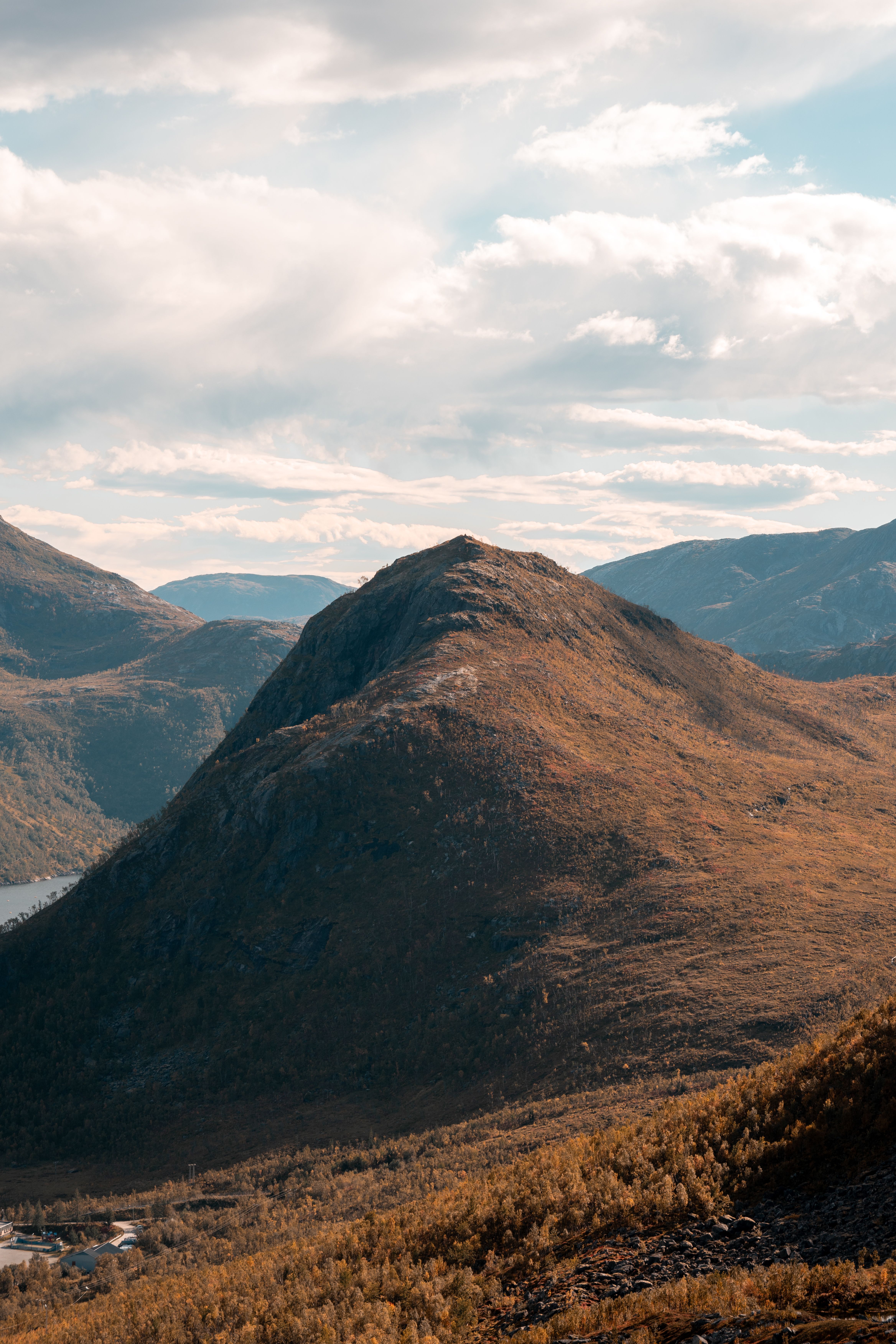 Breathtaking view of mountain peaks in Tromsø, Norway under a bright sky.