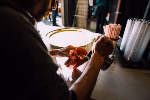 A barista carefully pours coffee into a cup at a cozy cafe.