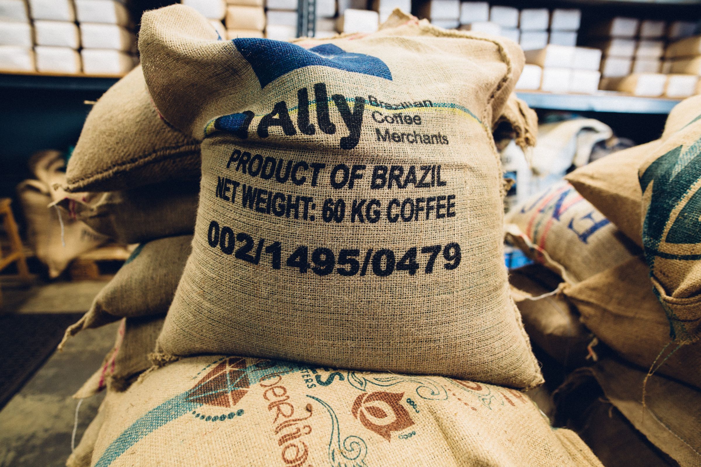 Stacked burlap coffee sacks in warehouse