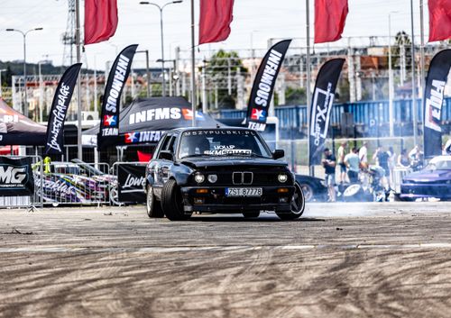 Free Exciting drift racing scene featuring a dynamic sports car in an urban setting during a competition. Stock Photo