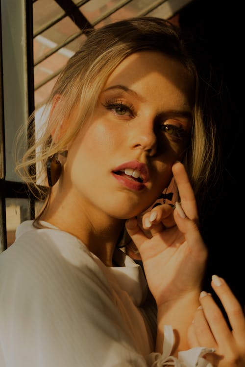 Woman Standing Near Glass Window