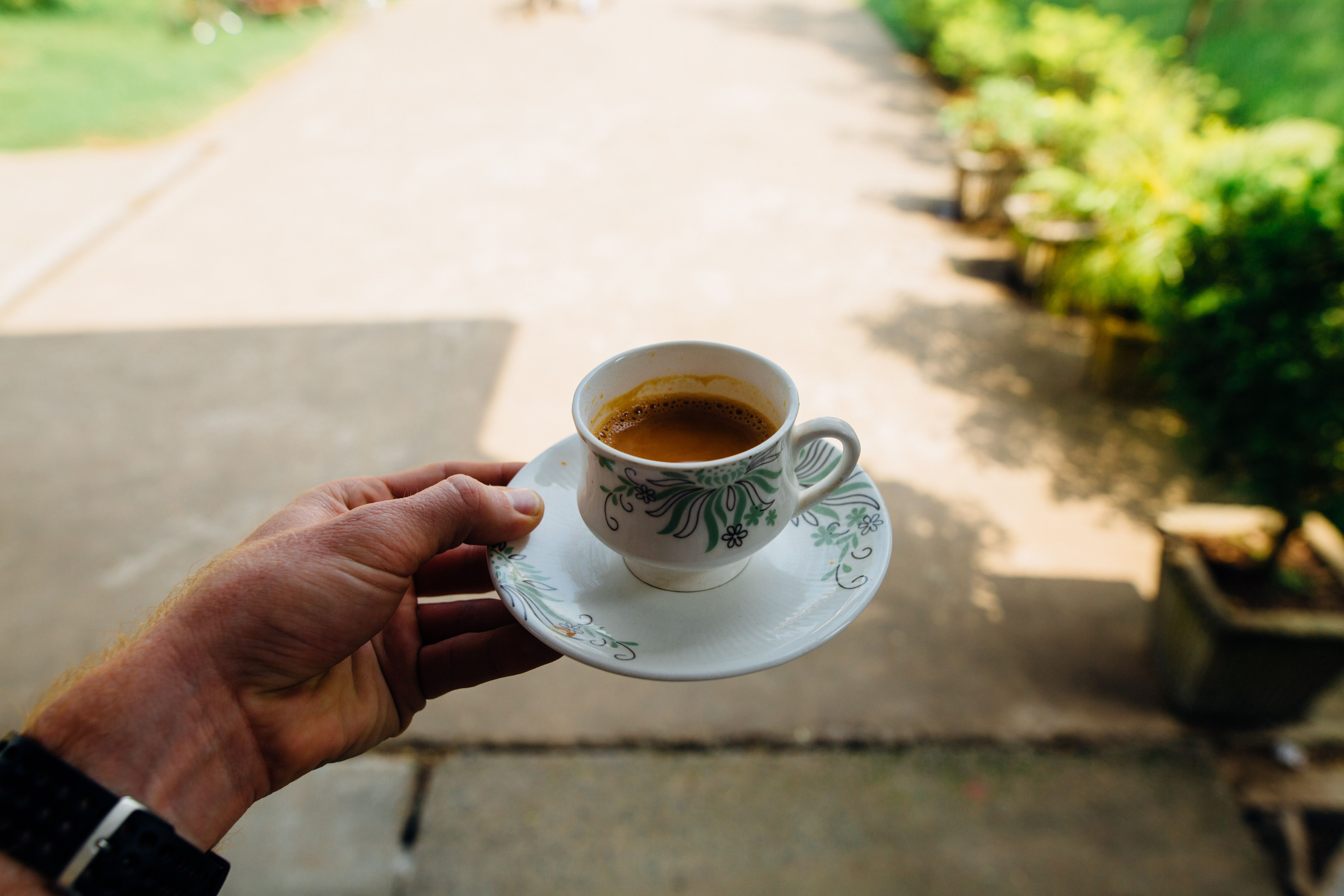 person enjoying morning coffee on patio - decaf coffee concentrate