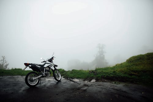 Honda Motorcycle Parked Near Green Field 